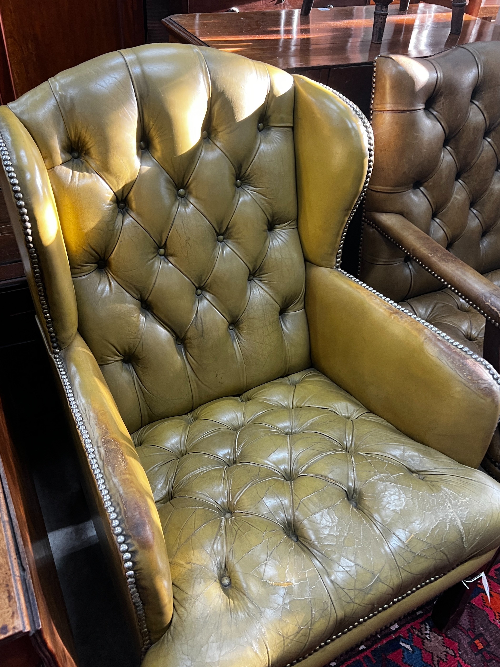 A George III style button green leather armchair, width 65cm, depth 68cm, height 98cm